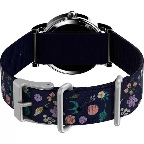 Timex Womens Watch Peanuts Weekender Casual Ladies Wristwatch  Featuring Snoopy and Woodstock in a Floral Motif SilverTone Case with Blue Fabric Strap 31mm