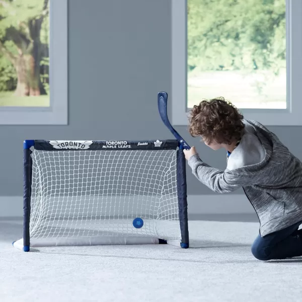 Franklin Sports NHL Mini Hockey Set  Kids Indoor Knee Hockey Goal Ball  2 Mini Hockey Stick Combo Set  Youth NHL Team Indoor Toy Knee Hockey Sets  NHL Official  Ages 3Toronto Maple Leafs
