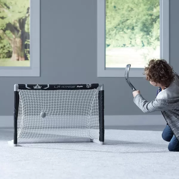 imageFranklin Sports NHL Mini Hockey Set  Kids Indoor Knee Hockey Goal Ball  2 Mini Hockey Stick Combo Set  Youth NHL Team Indoor Toy Knee Hockey Sets  NHL Official  Ages 3Los Angeles Kings