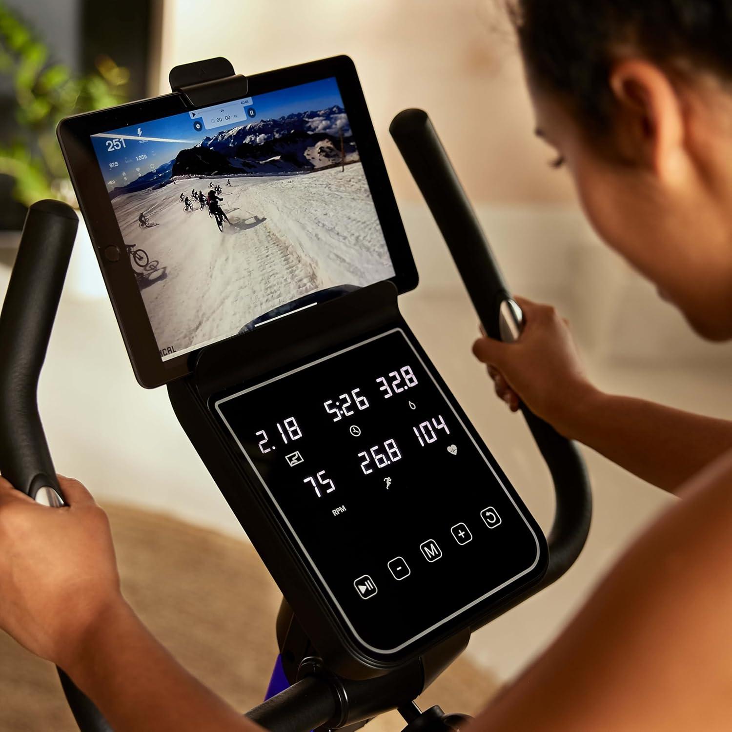 imageReebok Fitness Stationary Bike Bluetooth Compatible Indoor Cycling Bike 24 Resistance Levels 12 Workouts Upright Exercise Bike with Gel Pad SaddleBlue
