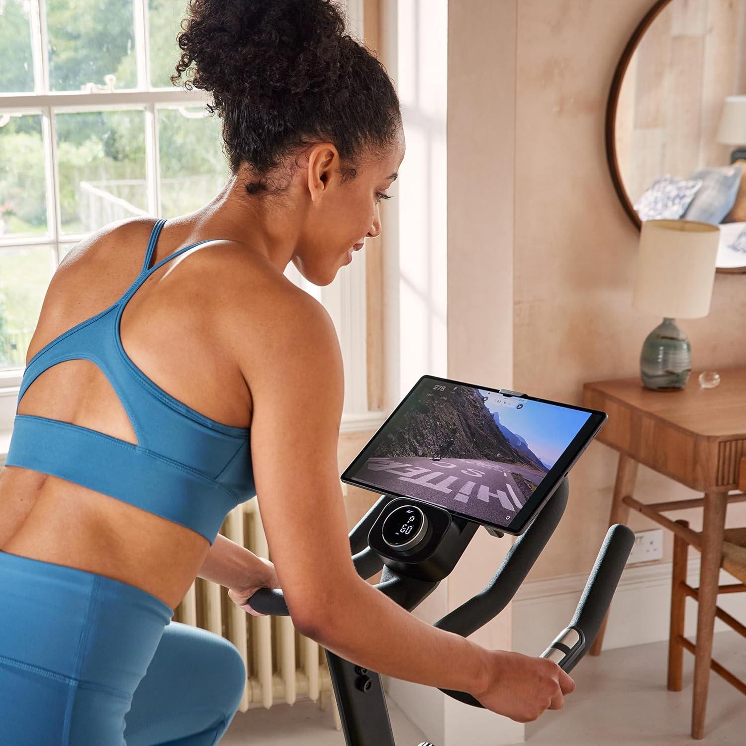 imageReebok Fitness Stationary Bike Bluetooth Compatible Indoor Cycling Bike 24 Resistance Levels 12 Workouts Upright Exercise Bike with Gel Pad SaddleReebok FR30 Sprint Bike