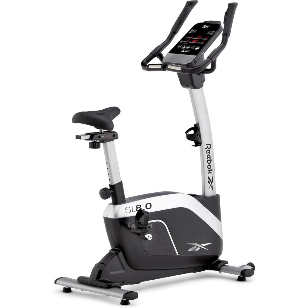 imageReebok Fitness Stationary Bike Bluetooth Compatible Indoor Cycling Bike 24 Resistance Levels 12 Workouts Upright Exercise Bike with Gel Pad SaddleSilver